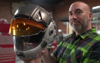 Frank Ippolito of Thingergy holding a Markforged 3D printed space helmet prop