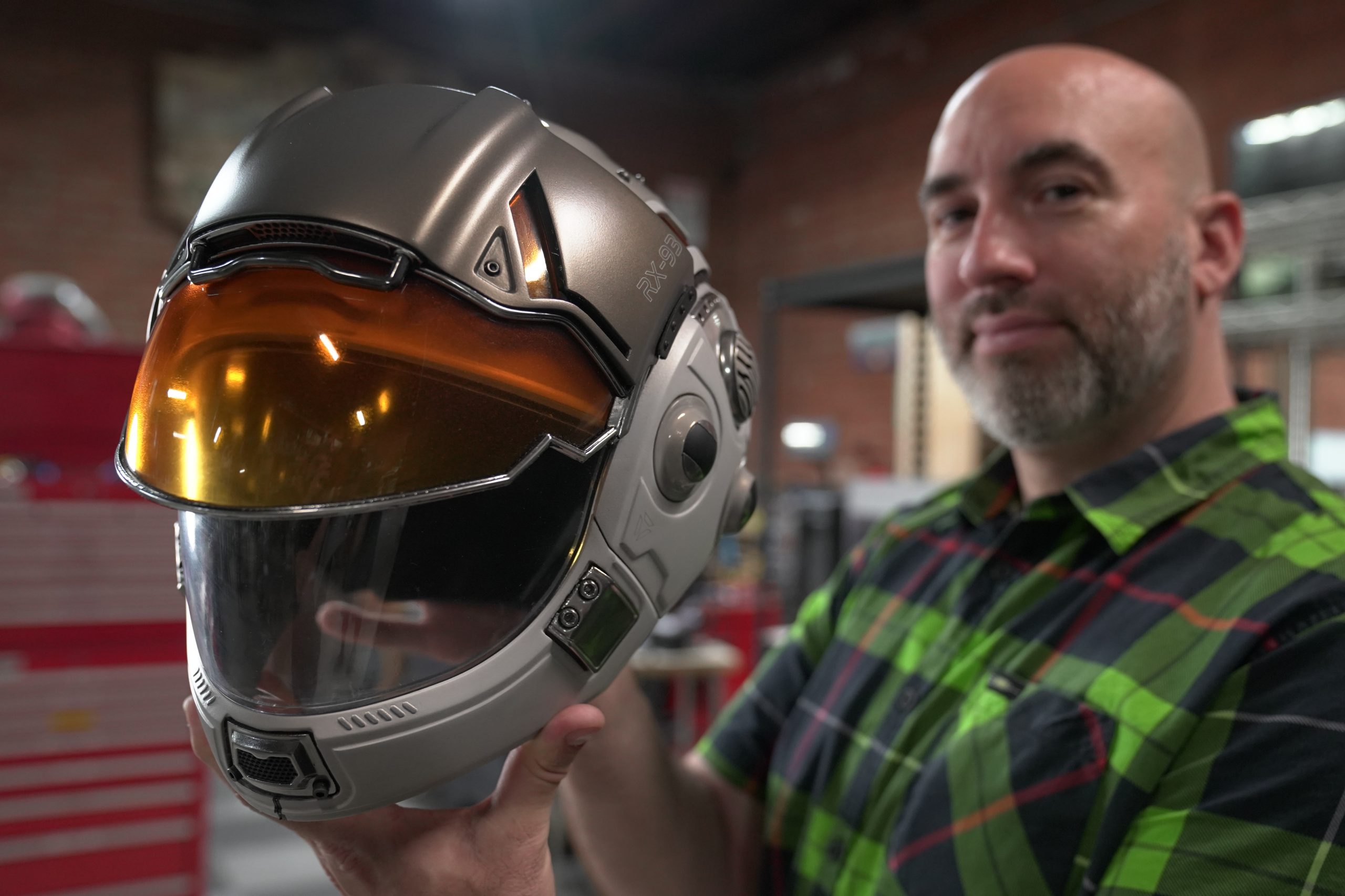 Frank Ippolito of Thingergy holding a Markforged 3D printed space helmet prop
