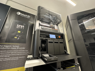 A Markforged FX10 3D Printer in the Mark3D UK showroom, with its material cabinet open, showing the internal spool bays for 3D printing materials.
